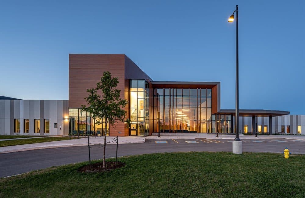 Modern healthcare facility exterior illuminated at dusk