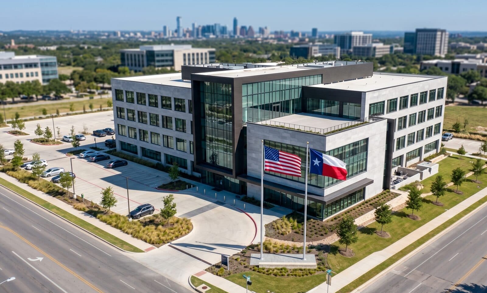 Aerial view of a modern Texas state agency headquarters with U.S. and Texas flags